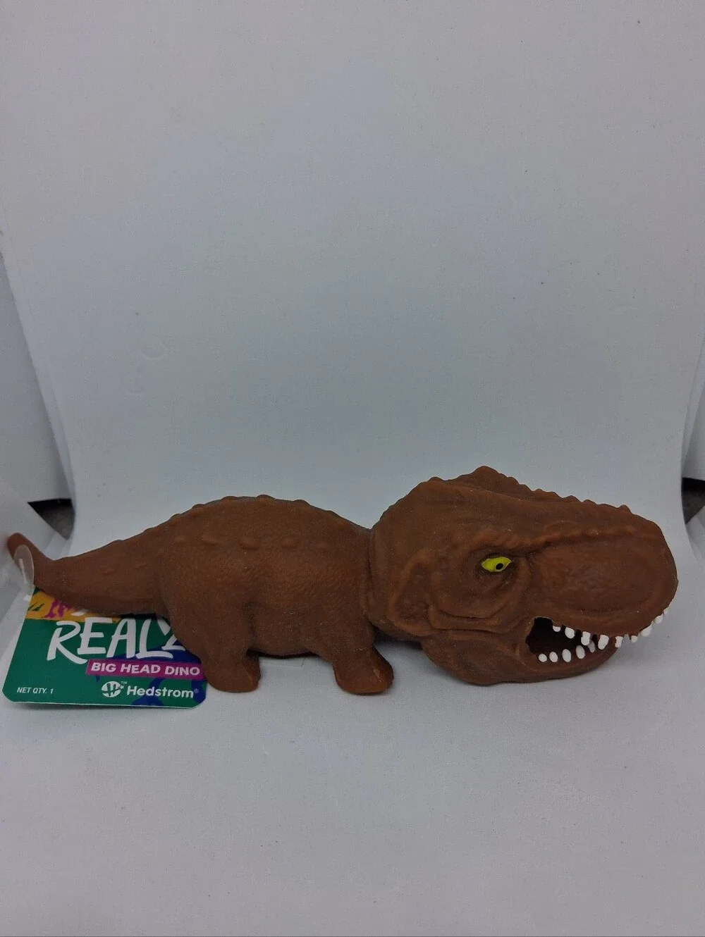 Crunchy Brown Big Head Dino Reptile Squishy Toy with Yellow Eyes